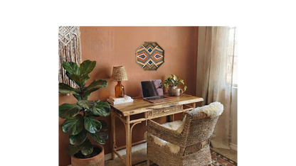 Ember Medallion geometric wood wall art displayed above a boho rattan desk in a warm terracotta office